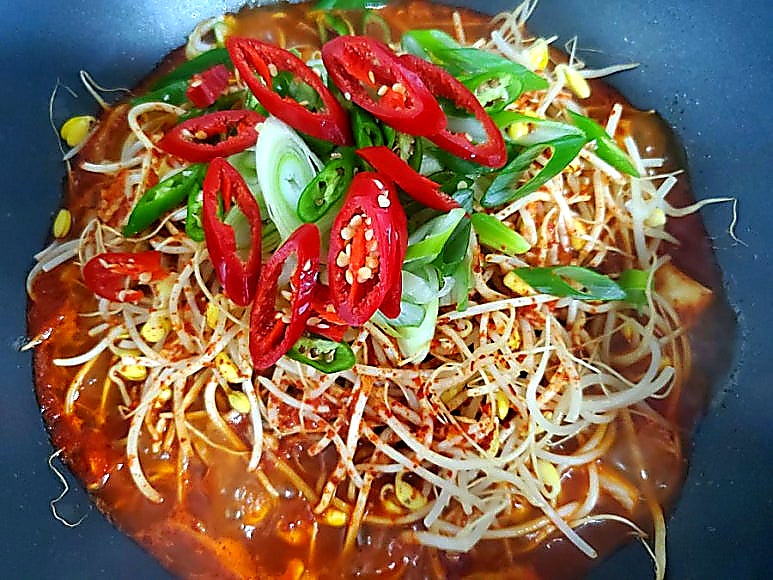 Adding chilies and scallions